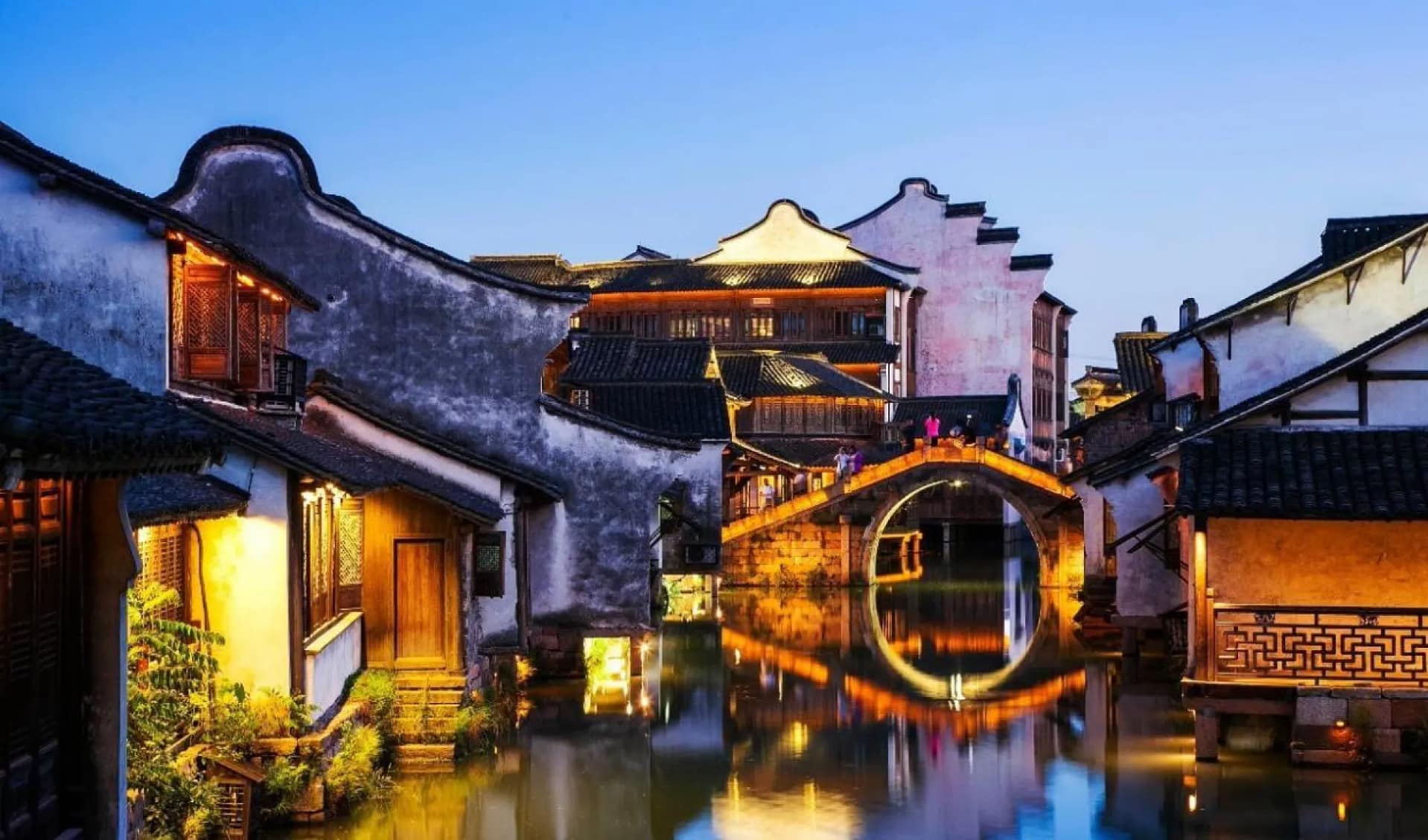Stone bridge and waterside houses in Wuzhen at night